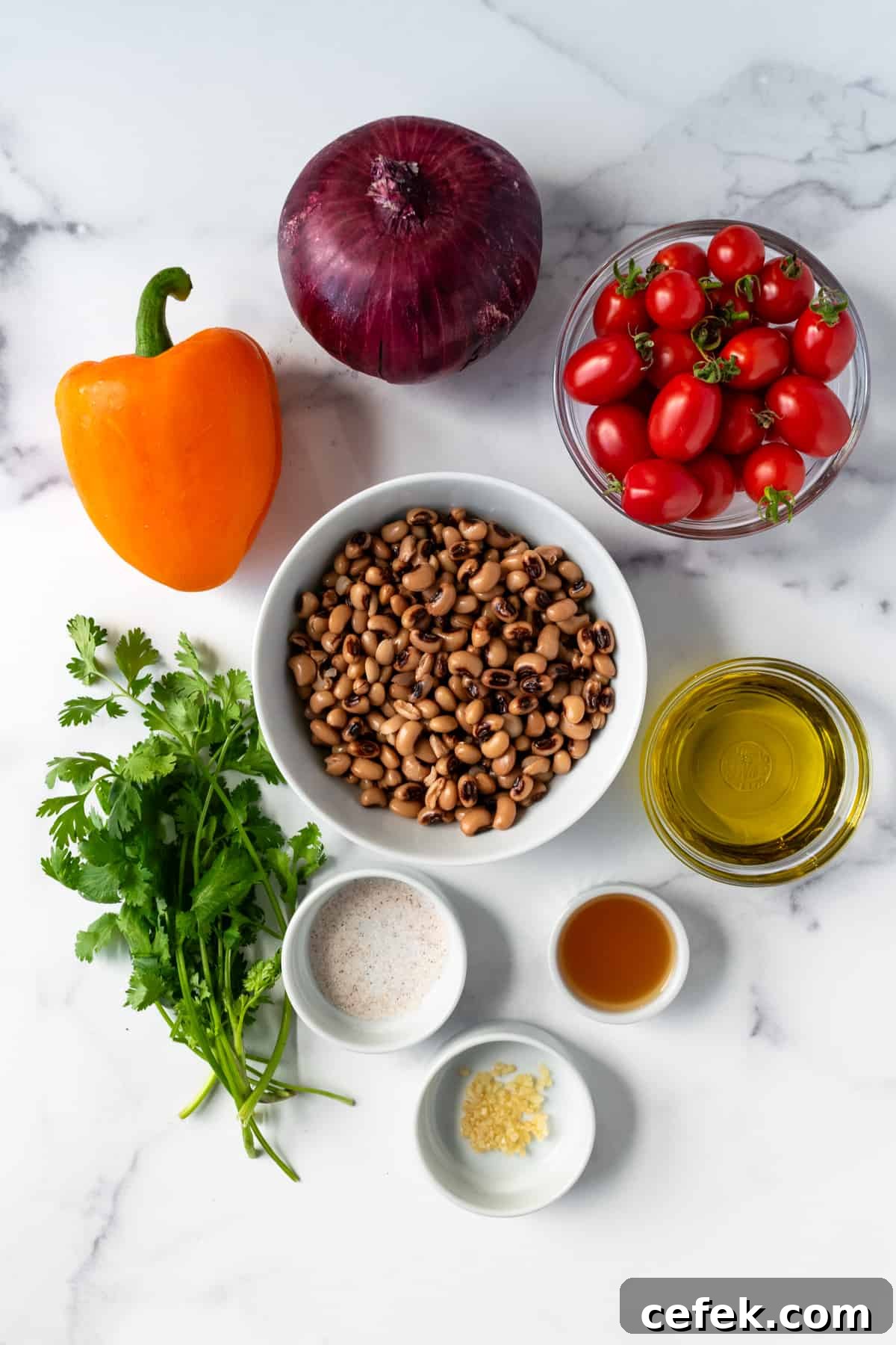 Black Eyed Pea Salad Ingredients on a marble countertop.