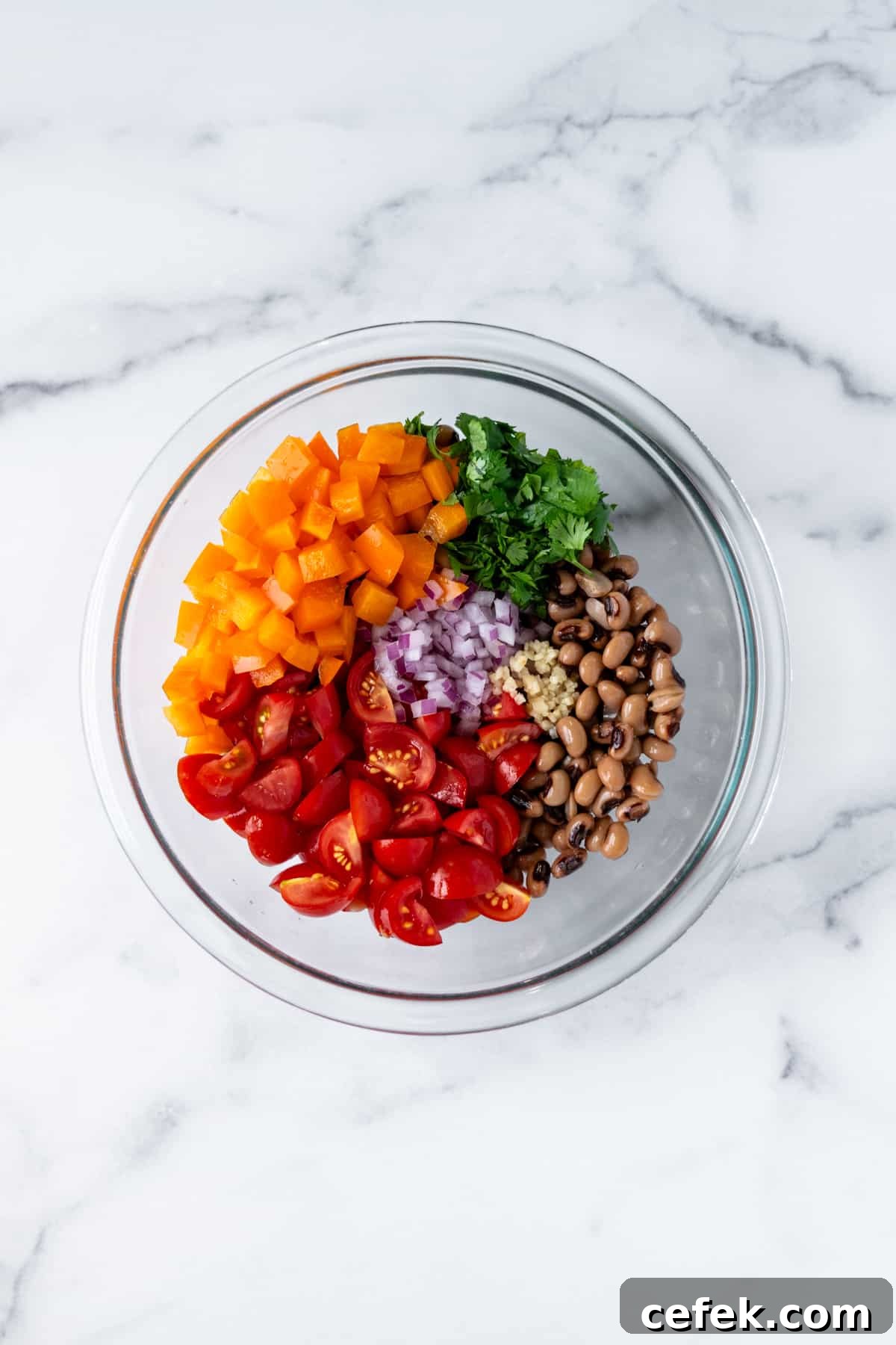 Black Eyed Pea Salad Ingredients in a glas mixing bowl.
