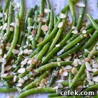 lemon garlic roasted green beans on baking sheet with almonds