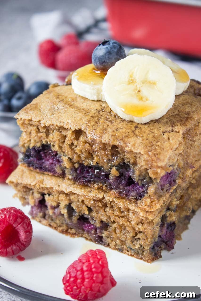 Healthy oven baked Blueberry Pancake Casserole topped with banana and raspberries