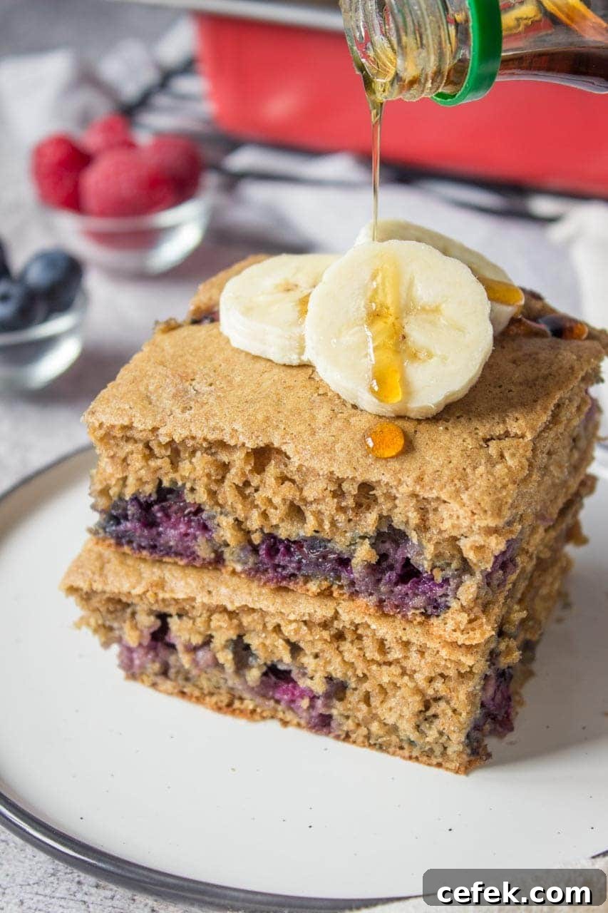 Healthy oven baked Blueberry Pancake Casserole topped with banana and raspberries