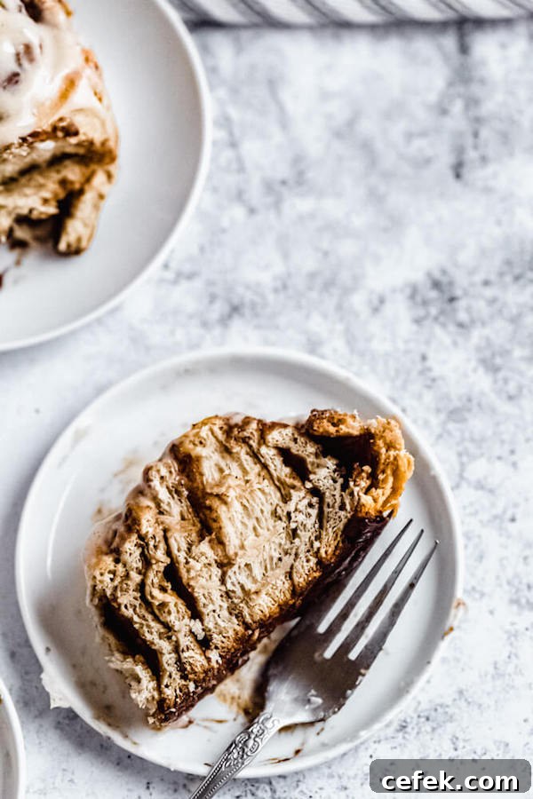chai cinnamon roll cut in half on an appetizer plate