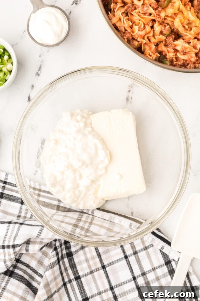cottage cheese and cream cheese in a glass mixing bowl before blending