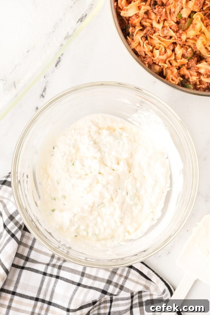 smooth cottage cheese mixture with green onions fully combined in a glass bowl