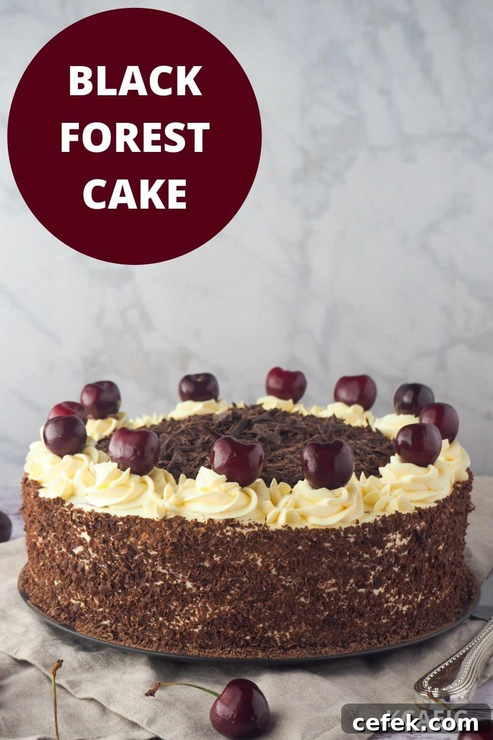Cake with fresh cherries and silver serving utensils, with text overlay, black forest cake and KCAEIC.