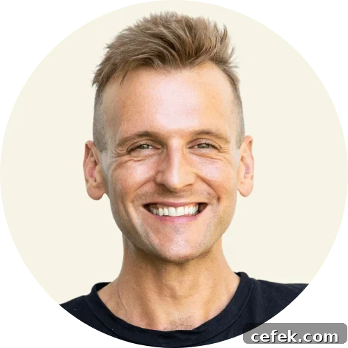 Kaleb Wyse wearing black shirt with a tan background.