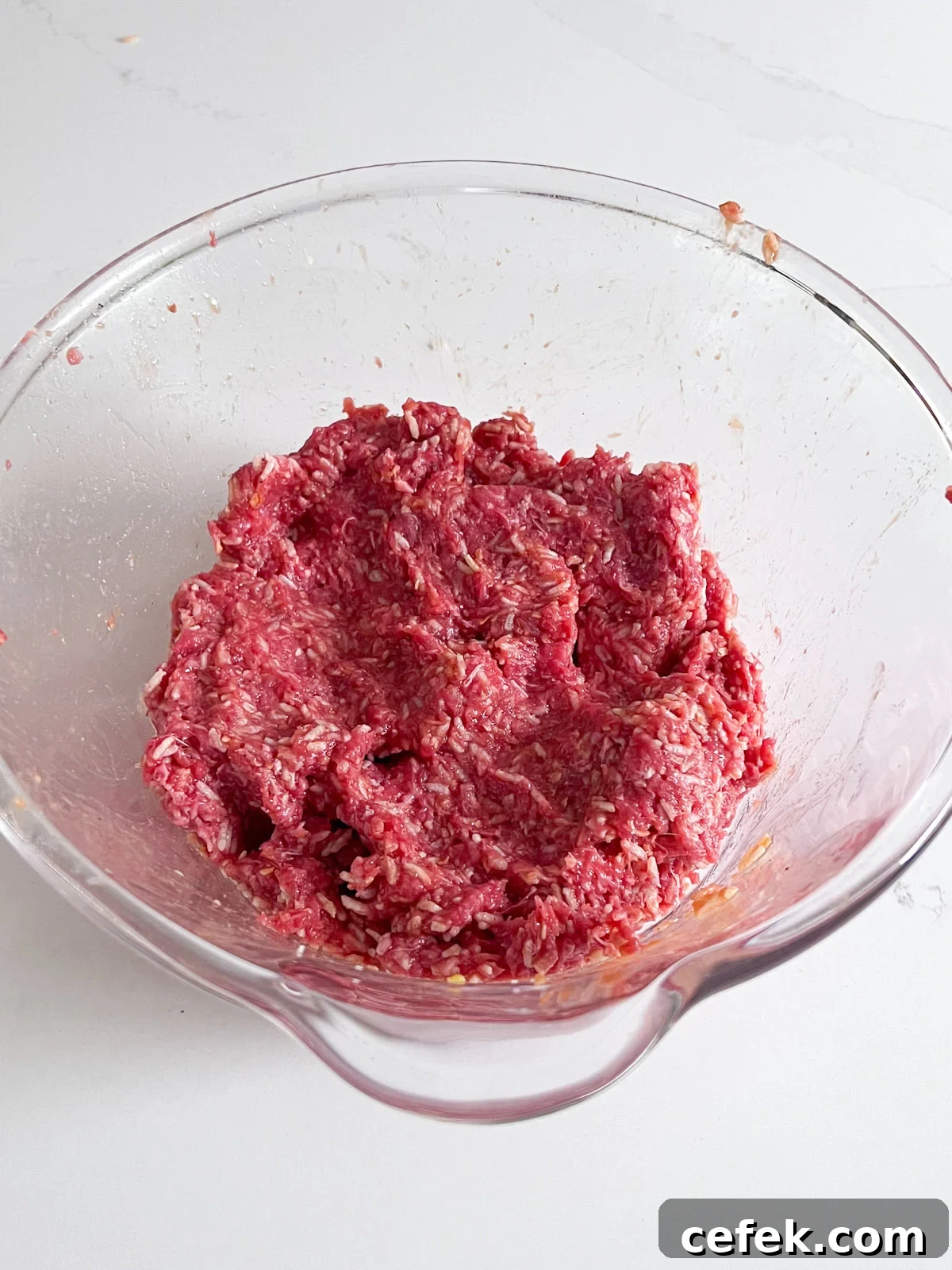 Meatball ingredients combined in the bowl.