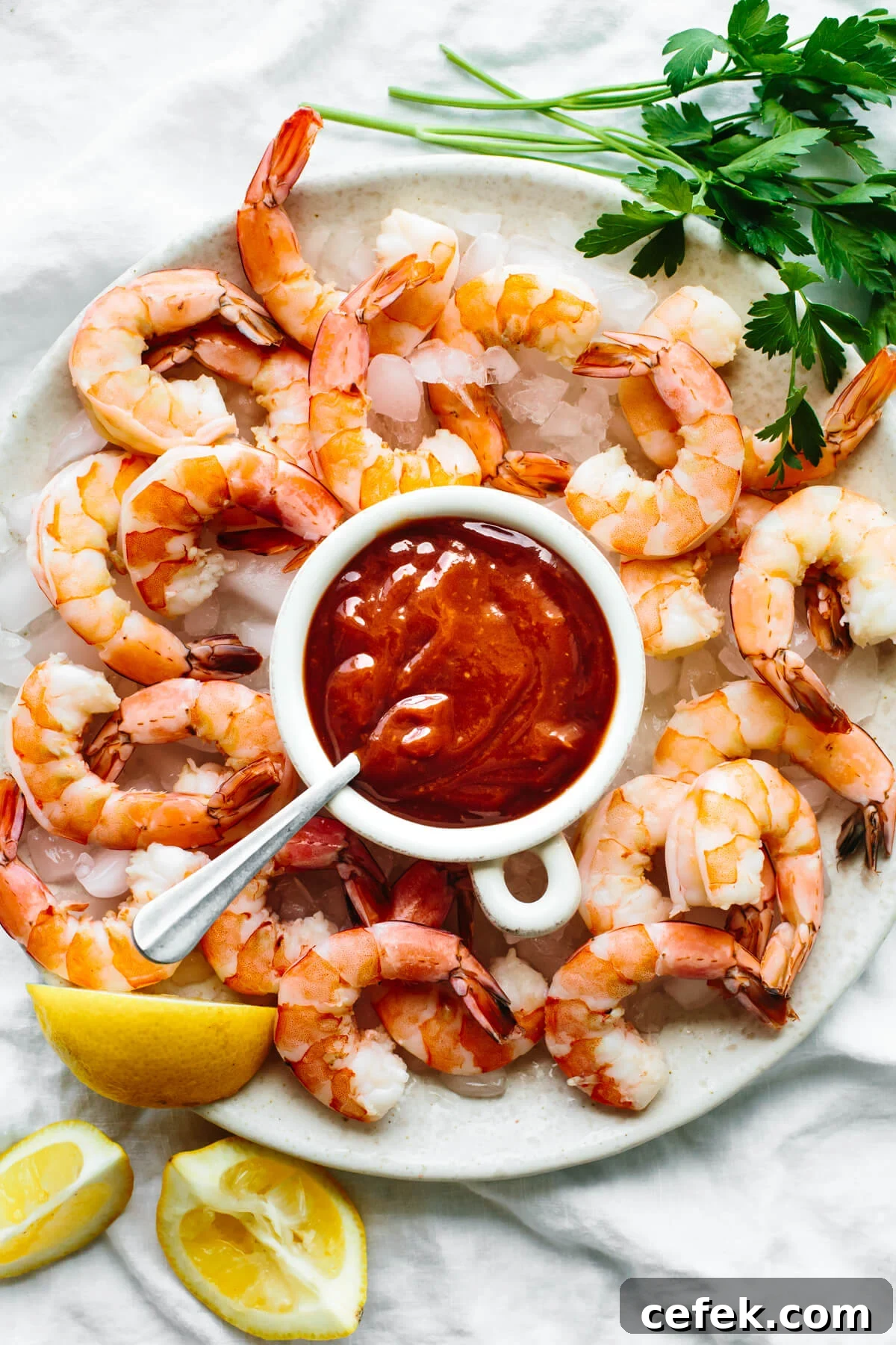 Shrimp cocktail on a platter with sauce.