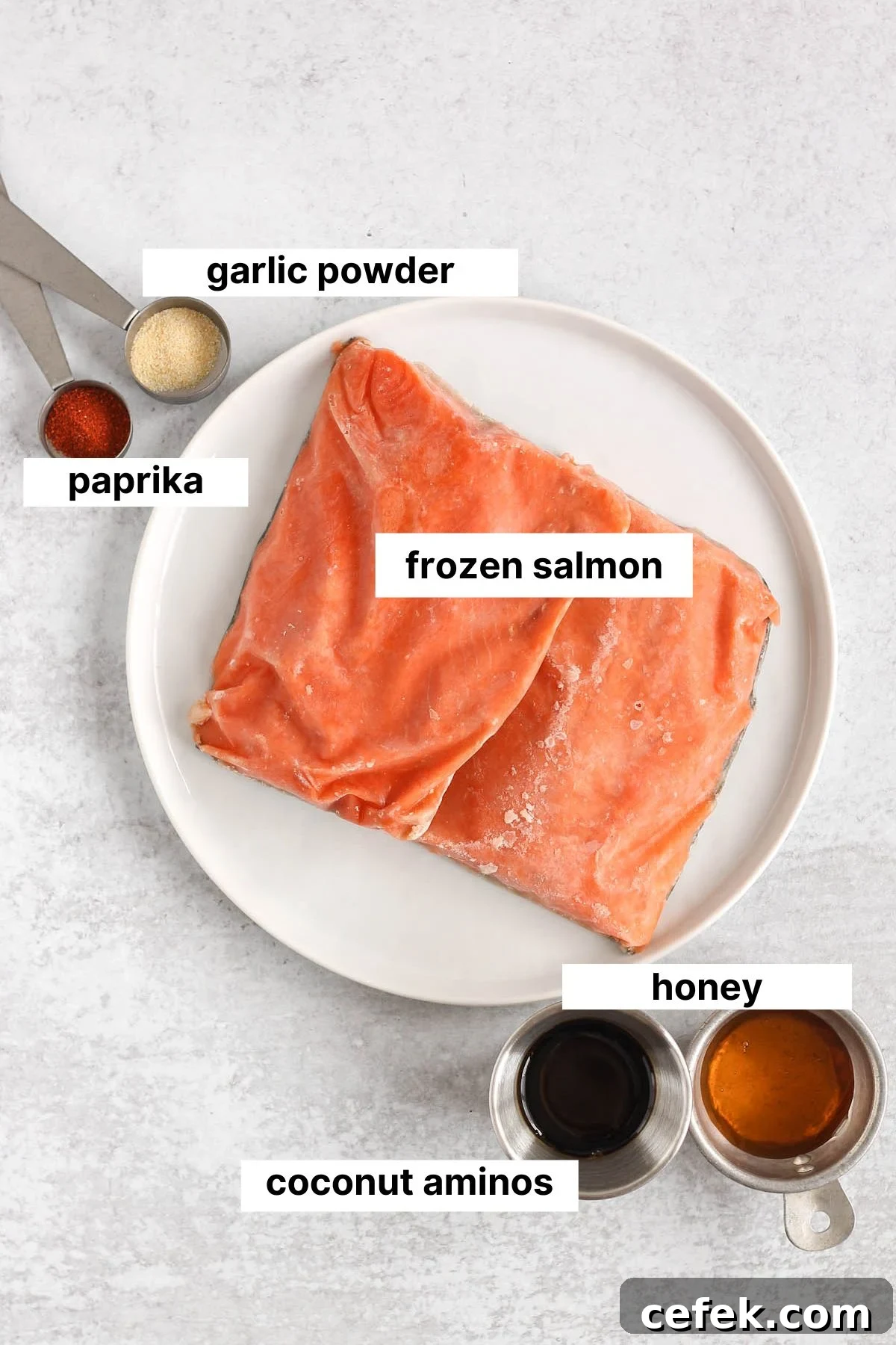Labeled ingredients needed for frozen salmon in the air fryer.