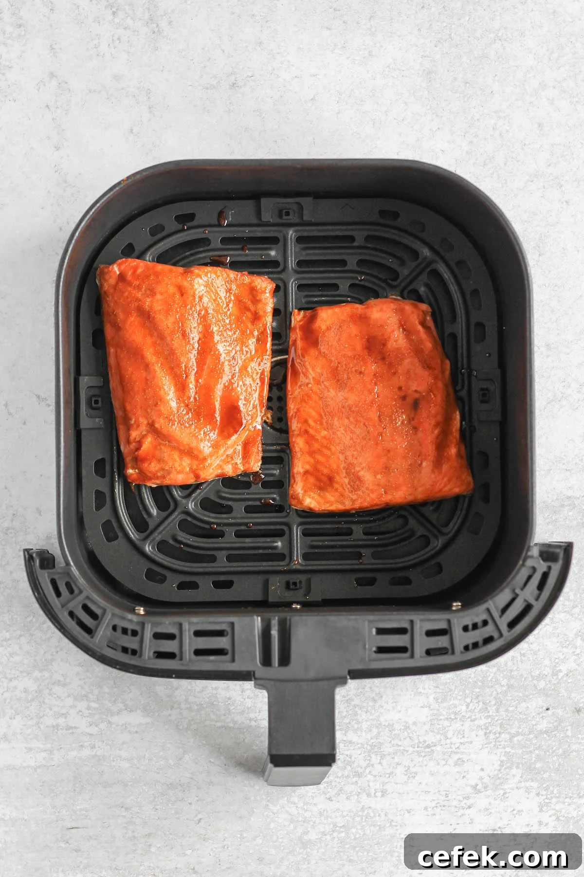 Salmon fillets in air fryer with glaze.