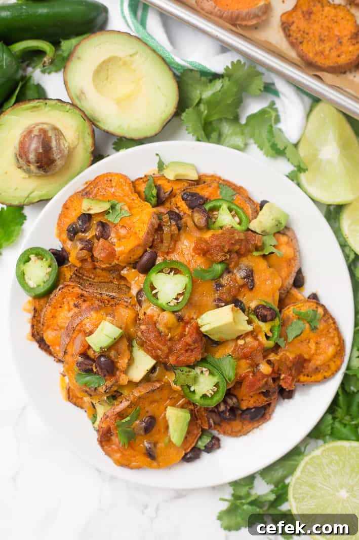 Loaded sweet potato nachos that are even better than traditional nachos! Healthy nachos with sweet potato, avocado, black beans, and melty cheese- what's not to love?!