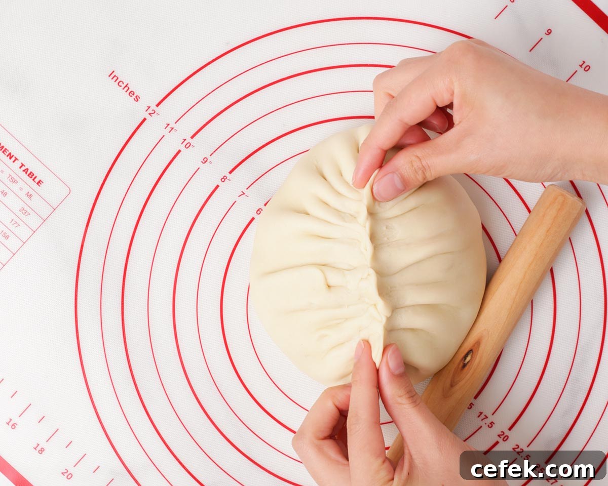 Pinching the dough closed.