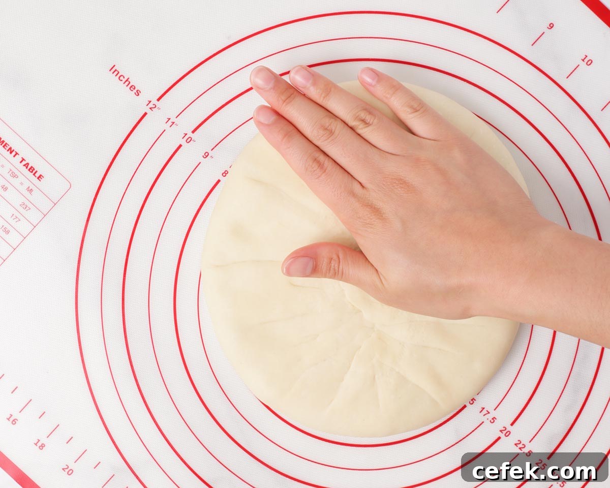 Flattening out the dough with the filling.