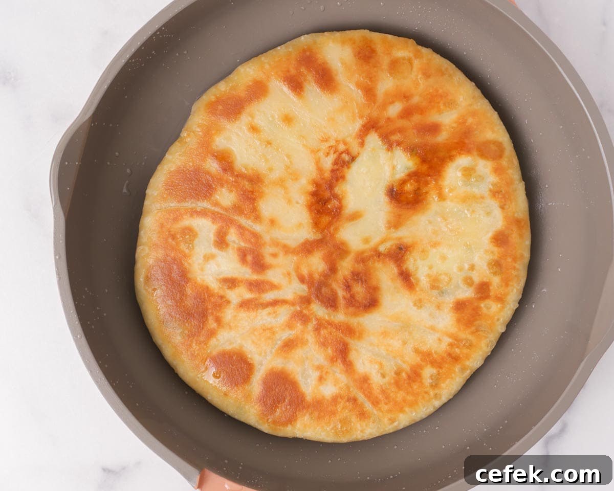 Flipping the dough in the pan.