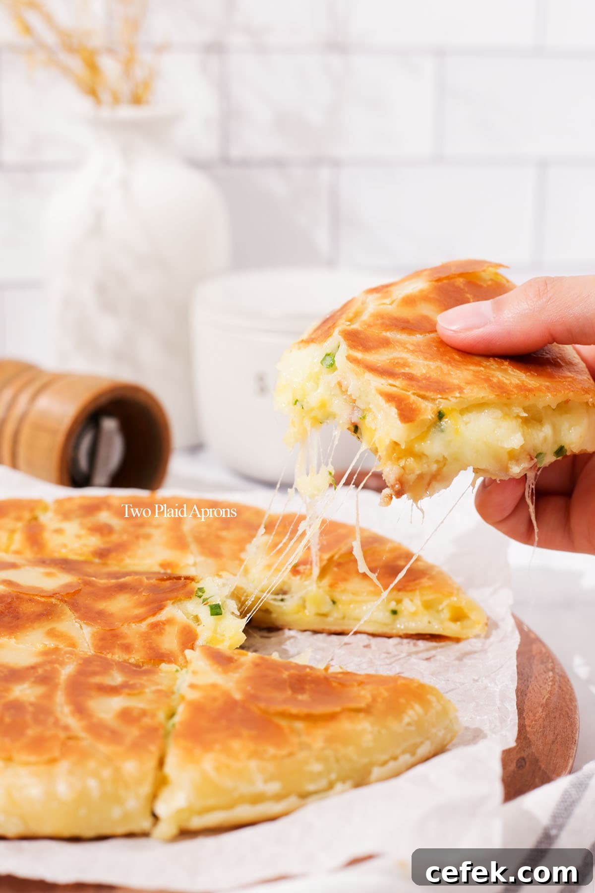Close up cheese pull of the cheesy loaded potato bread.