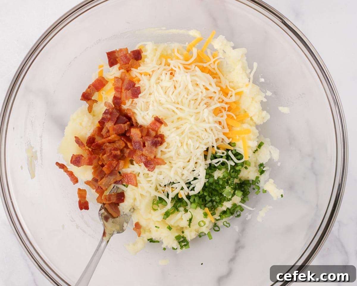 Adding bacon, cheeses, and green onion to the filling.