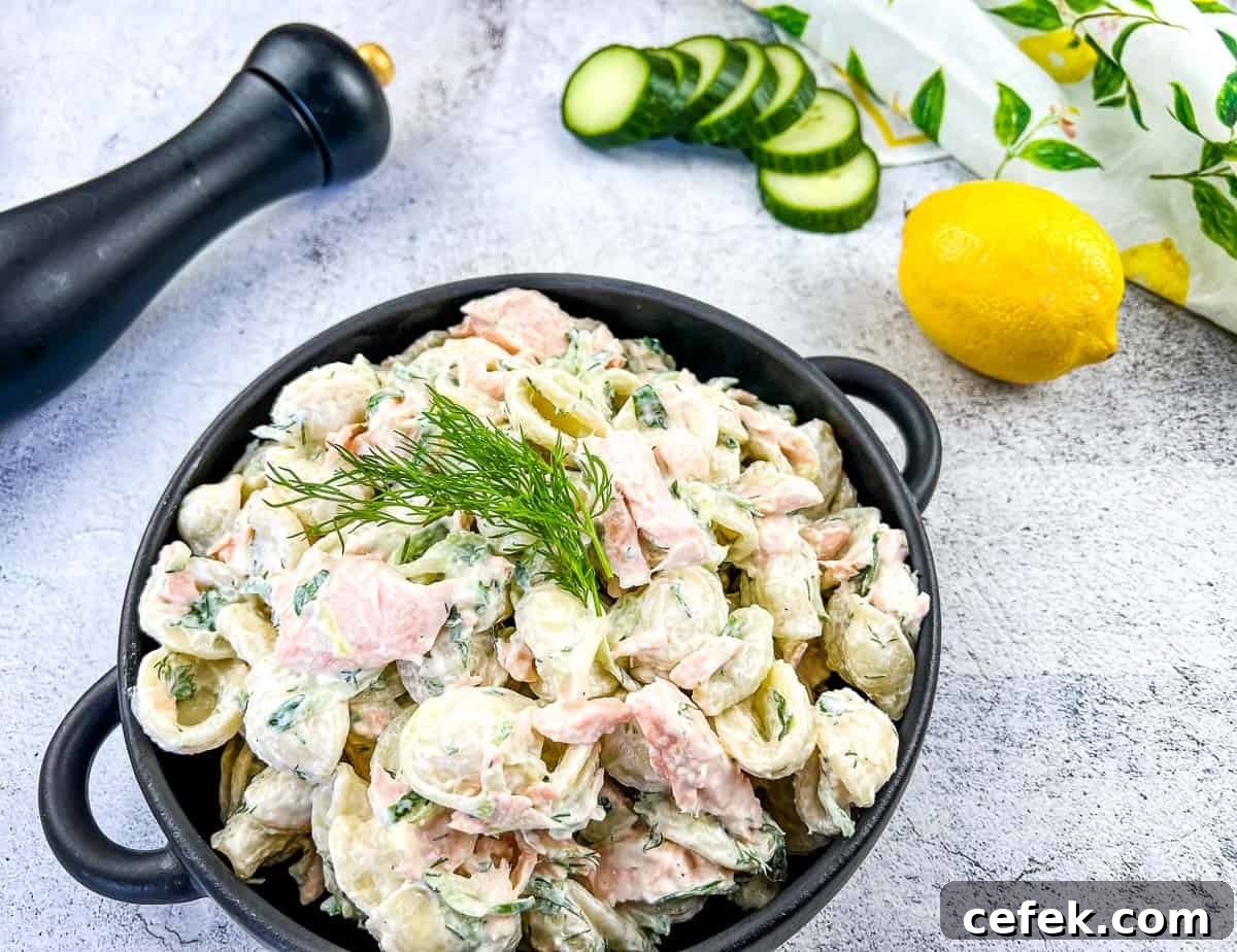 Salmon pasta salad in a black dish.