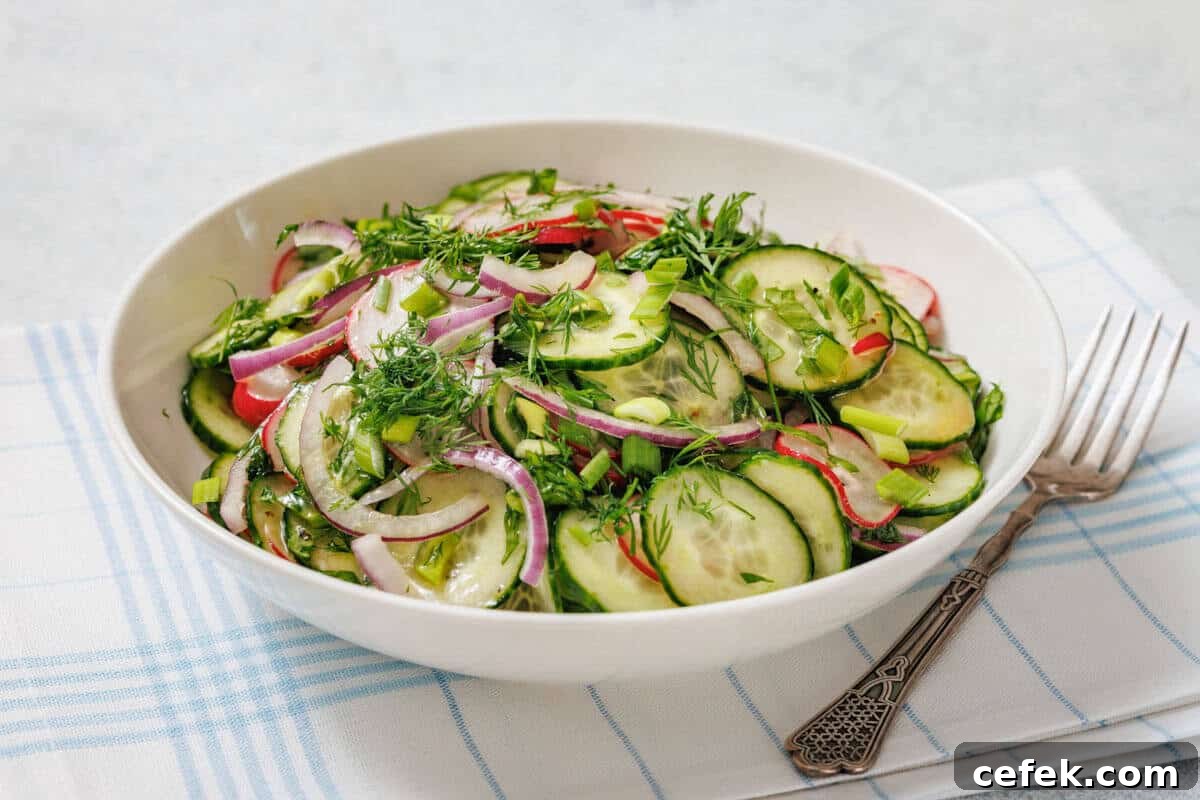 Bowl of Radish Salad with red onion, radishes, and fresh herbs on a plaid cloth, accompanied by a fork.