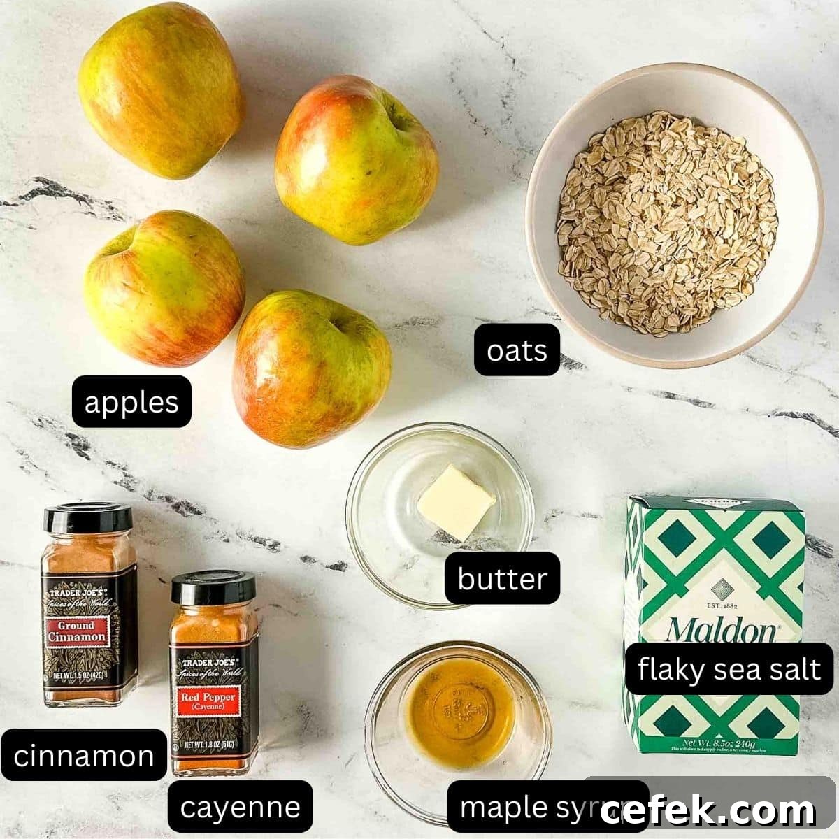 The ingredients for air fryer baked apples sit on a white marble counter.