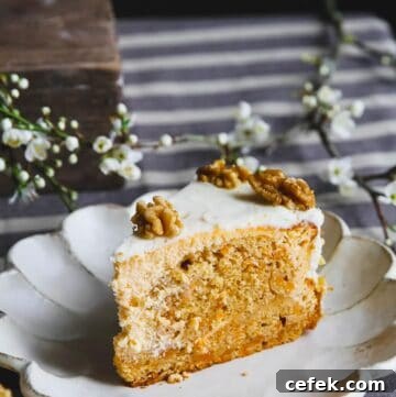 A close up of a carrot cake cheesecake slice on a white plate.