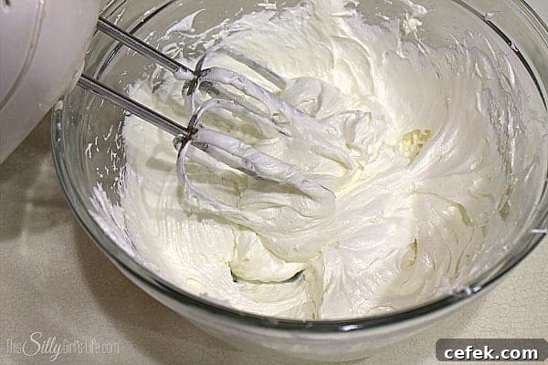 Place the cream cheese in a large bowl and with a hand mixer, cream it on medium speed.
