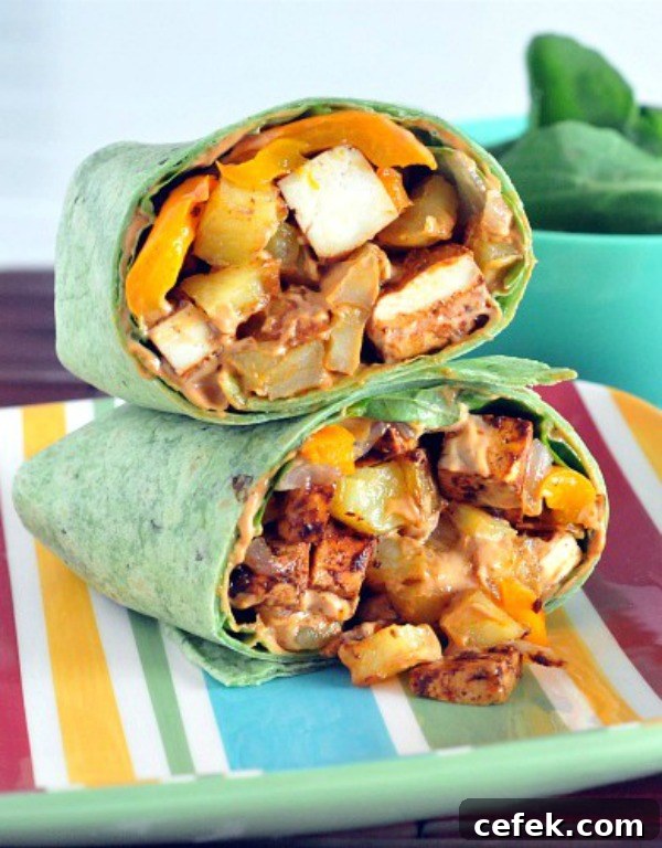 Chipotle Tofu Potato Burrito sliced in half and stacked on a plate