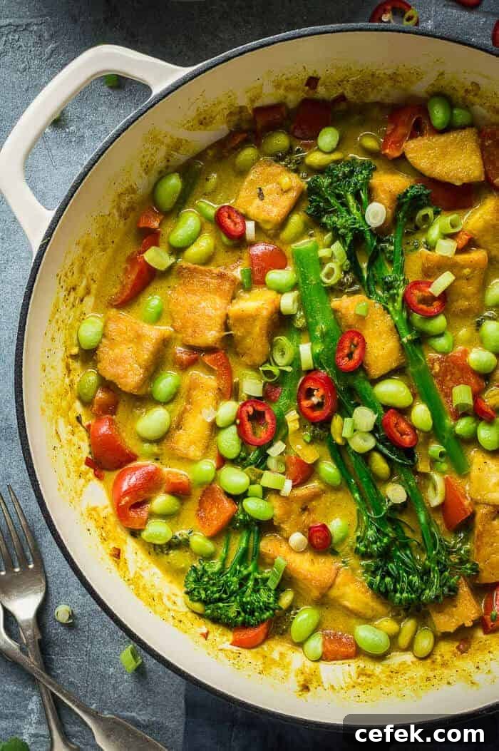 Close up of a cast iron pan of easy vegan lemongrass coconut curry with broccoli, tofu and edamame.