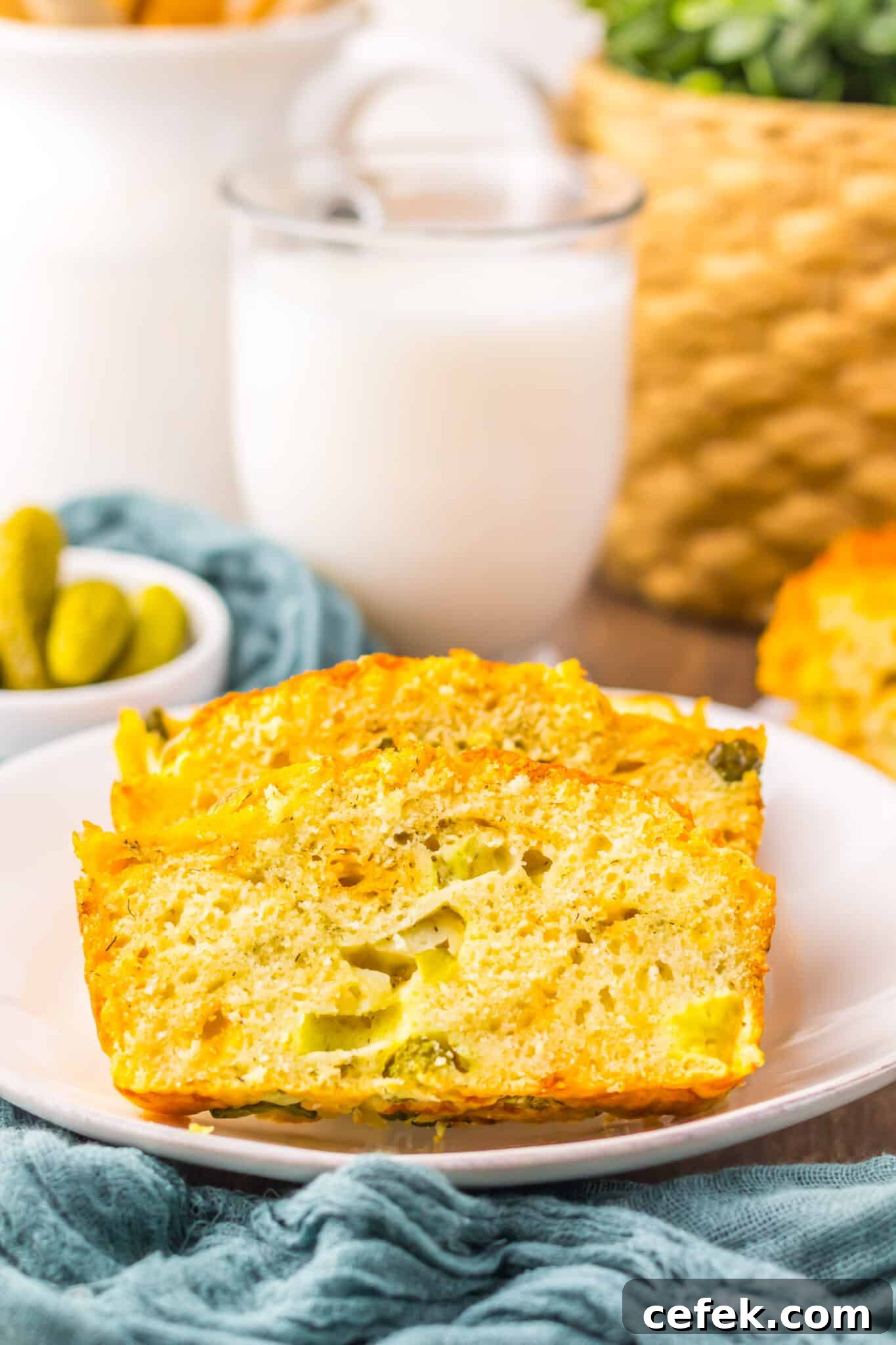 side view of slice of dill pickle bread with glass of milk