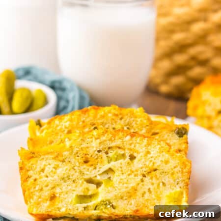 side view of slice of dill pickle bread with glass of milk
