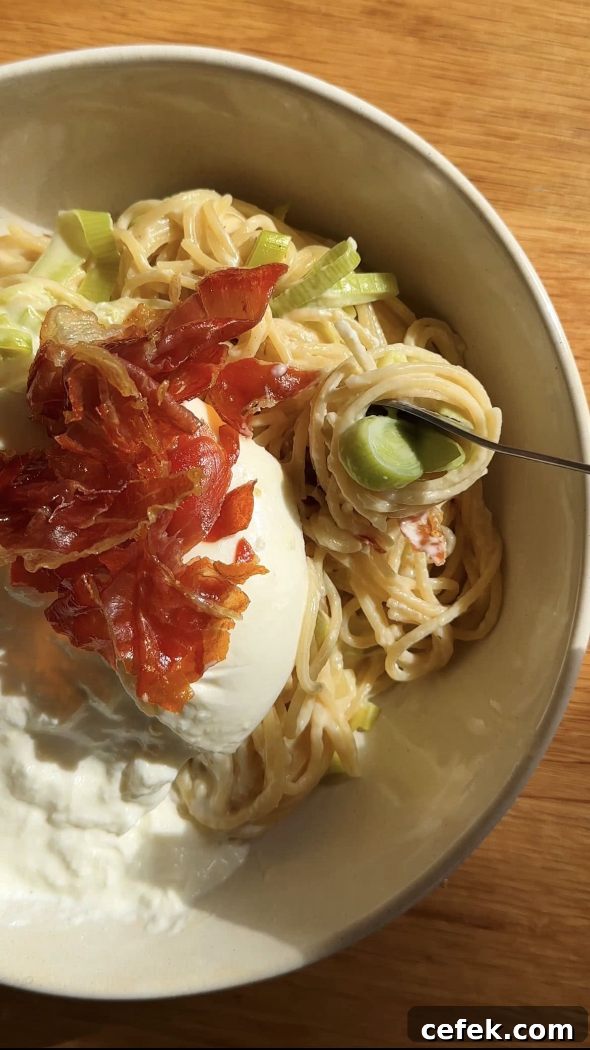 burrata and crispy parma ham on top of creamy leek pasta