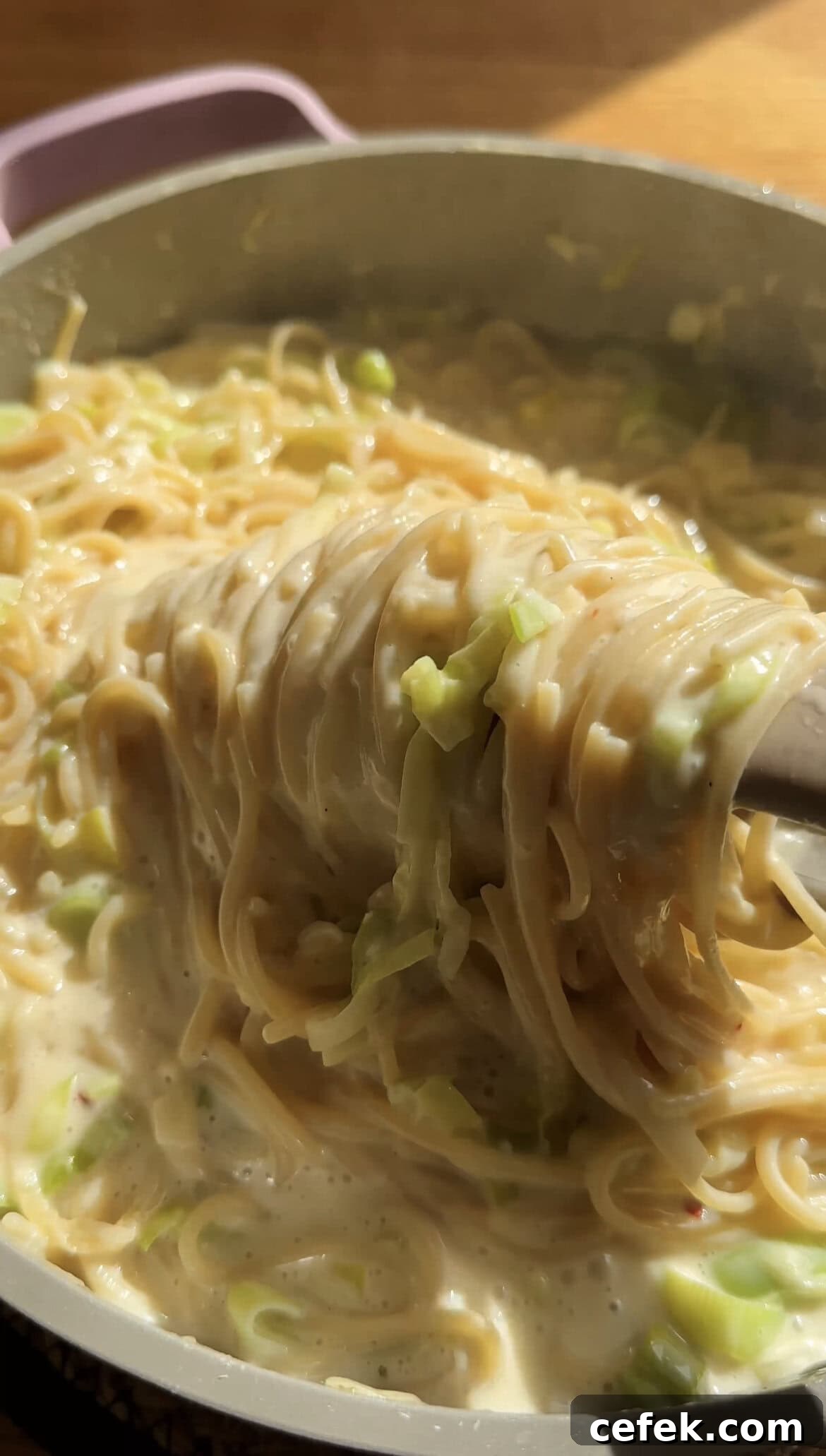 tongs twirling leek pasta