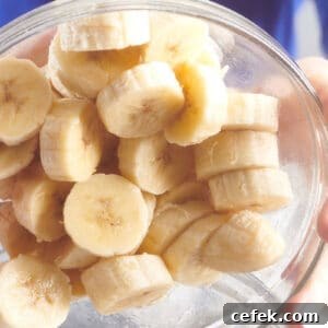 Woman pouring sliced bananas out of glass bowl.