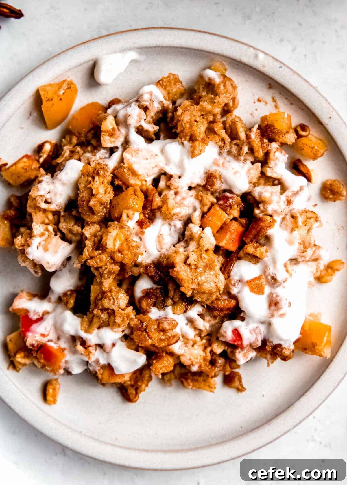 white plate full of baked apple cinnamon oatmeal with yogurt