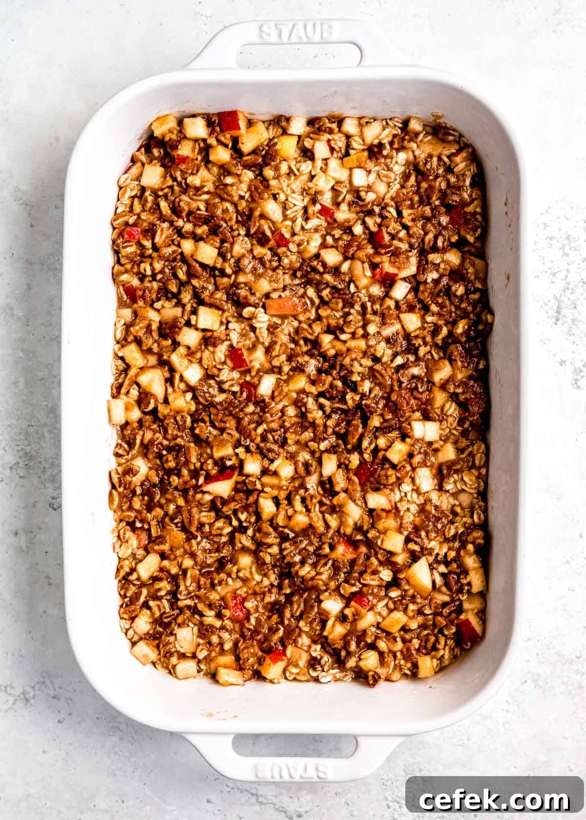 apple cinnamon topping on top of the oatmeal base in baking dish