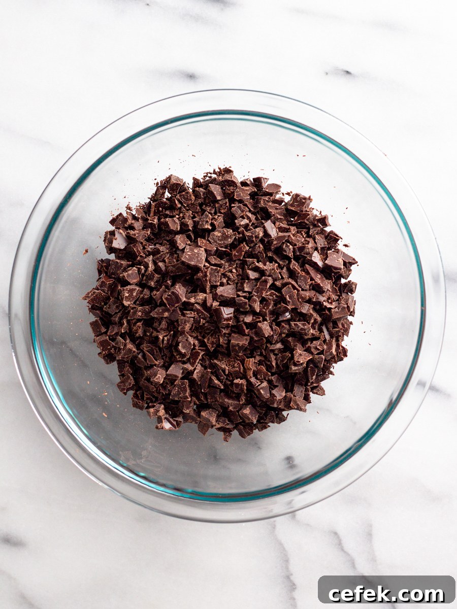 Perfect Chocolate Ganache Recipe for a Smooth, Glossy Finish 4 Chopped chocolate in a bowl.
