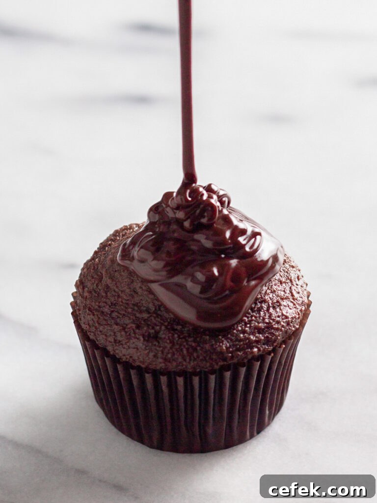 Perfect Chocolate Ganache Recipe for a Smooth, Glossy Finish 8 Chocolate ganache poured over a cupcake.