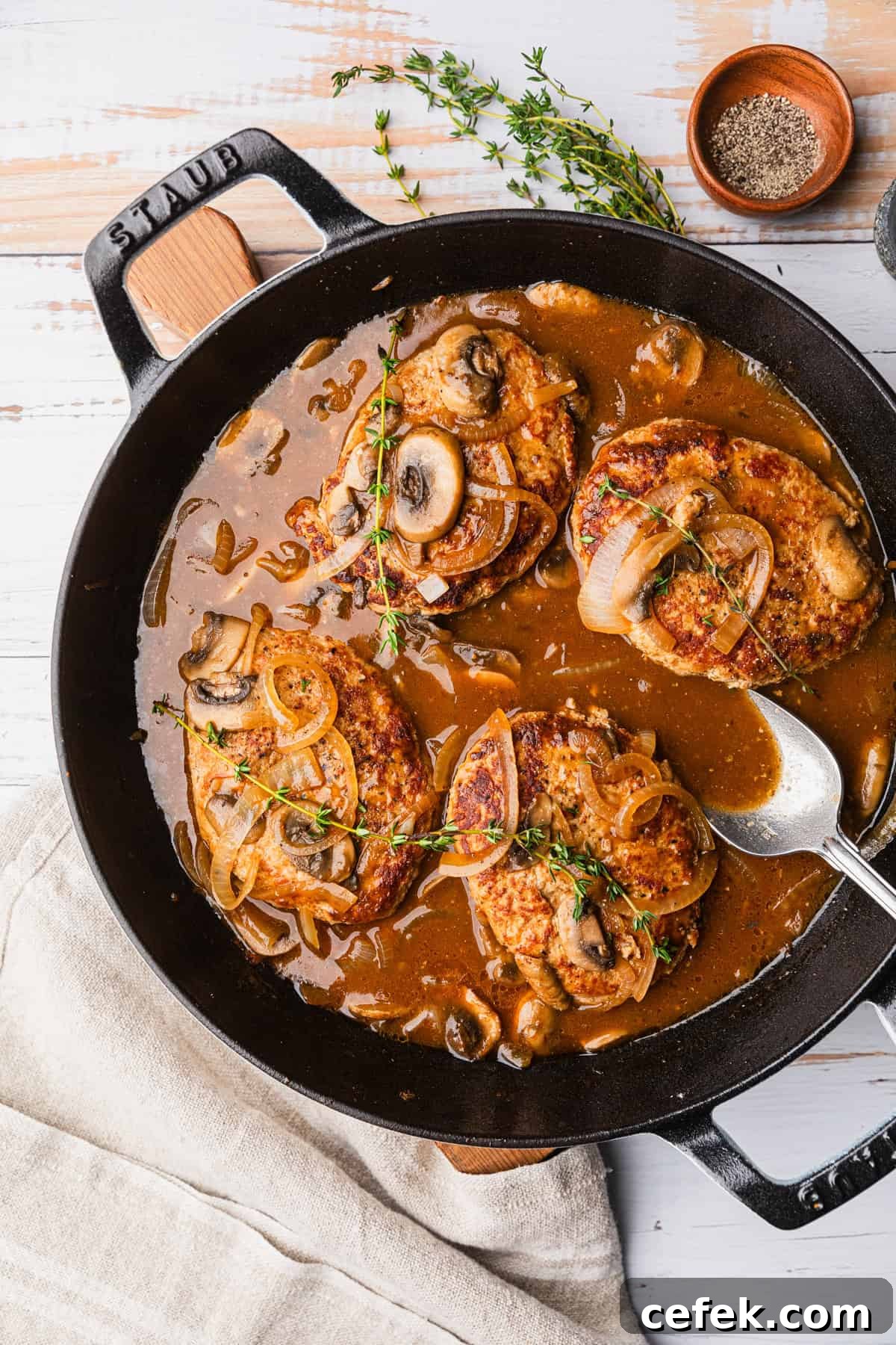 Ground Turkey Salisbury Steak with Mushroom Gravy 2 A skillet with turkey patties in a brown gravy.