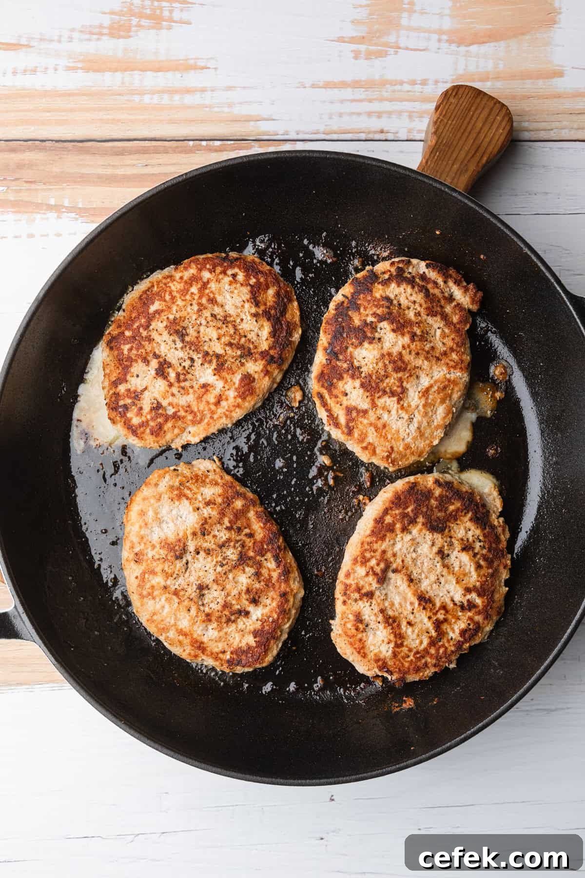Ground Turkey Salisbury Steak with Mushroom Gravy 6 Cooked turkey patties in the skillet.