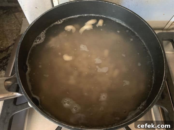 Creamy Gluten-Free Macaroni Salad 5 A pot filled with boiling macaroni.