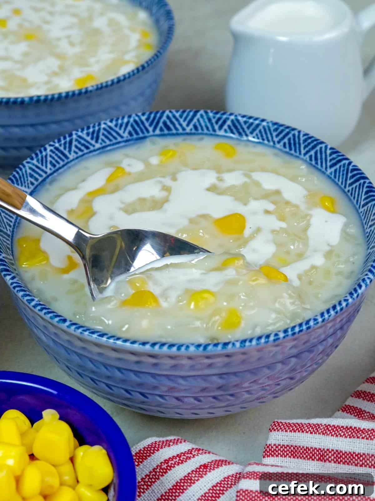 Creamy Filipino Corn and Coconut Milk Porridge 5 eating ginataang mais with a spoon.