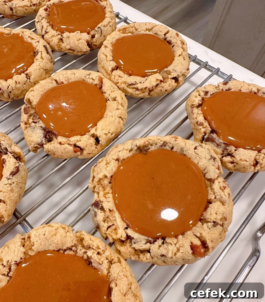 Carmelita cookies on a cooling rack with caramel centers.
