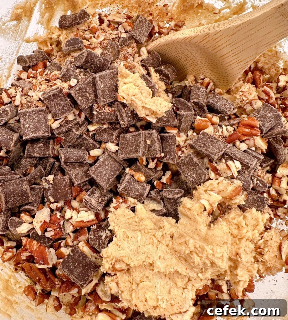 Adding in the chocolate chunks and pecans.