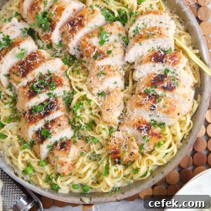 A skillet is filled with garlic parmesan chicken pasta.