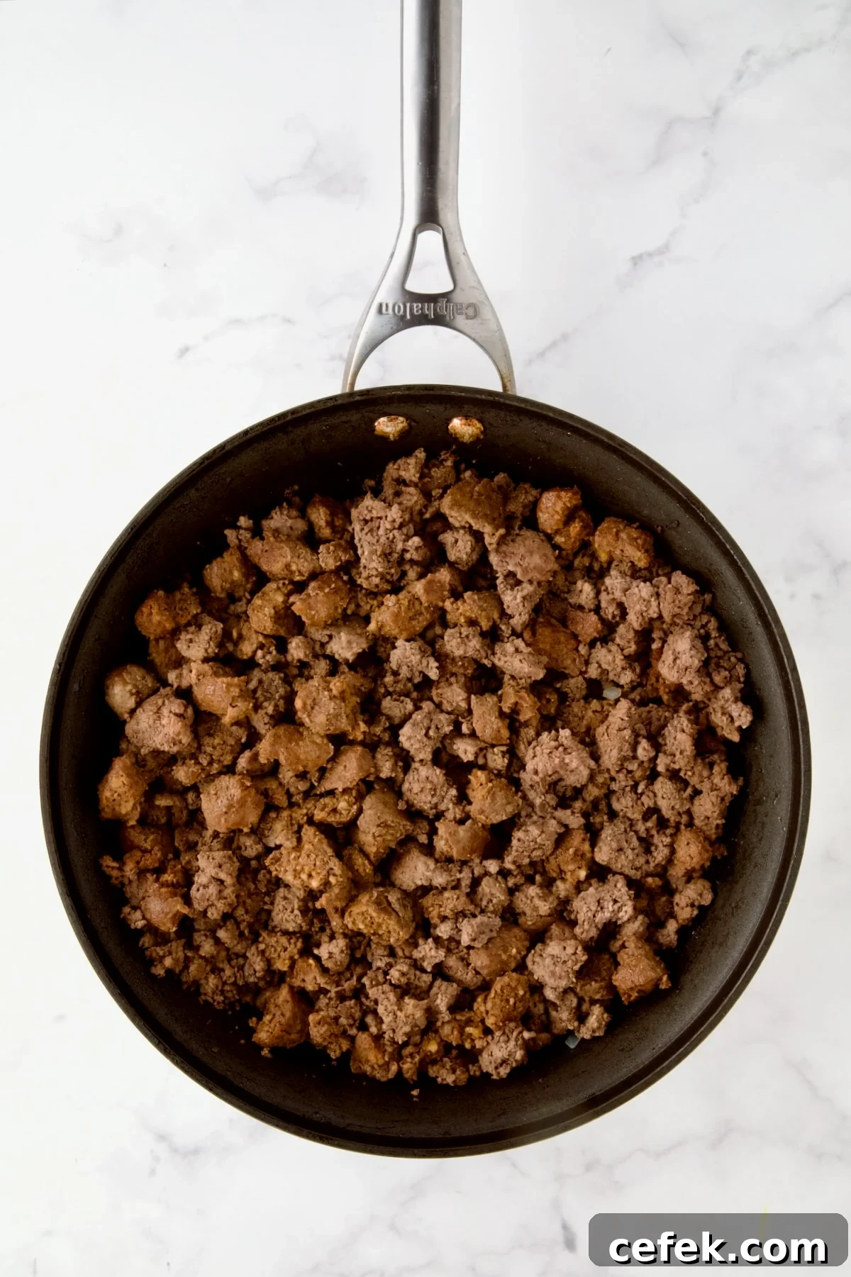 Browned ground beef and pork in nonstick skillet.
