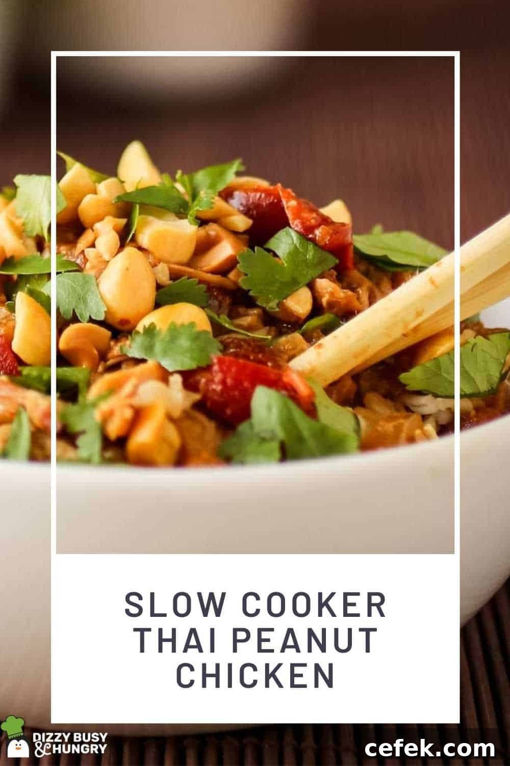 Spicy Slow Cooker Thai Peanut Chicken Recipe 2 Close up shot of Thai peanut chicken garnished with herbs in a white bowl on a wooden placemat with a fork.