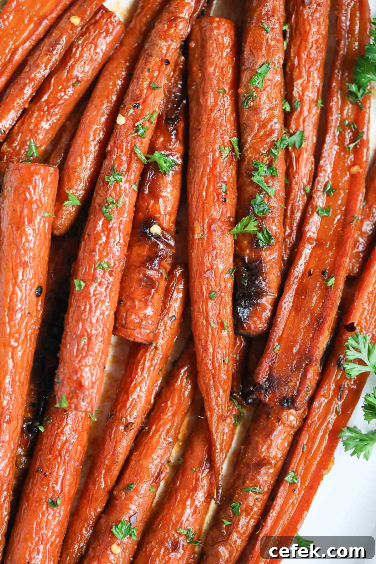 Maple-Glazed Roasted Carrots Recipe 2 Maple roasted carrots on a white platter.