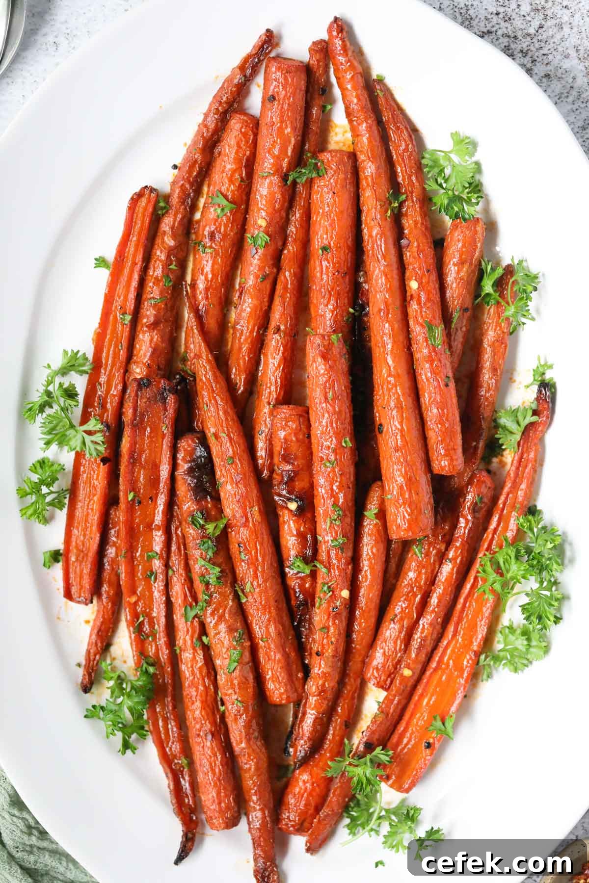 Maple-Glazed Roasted Carrots Recipe 5 Maple roasted carrots on a white platter.