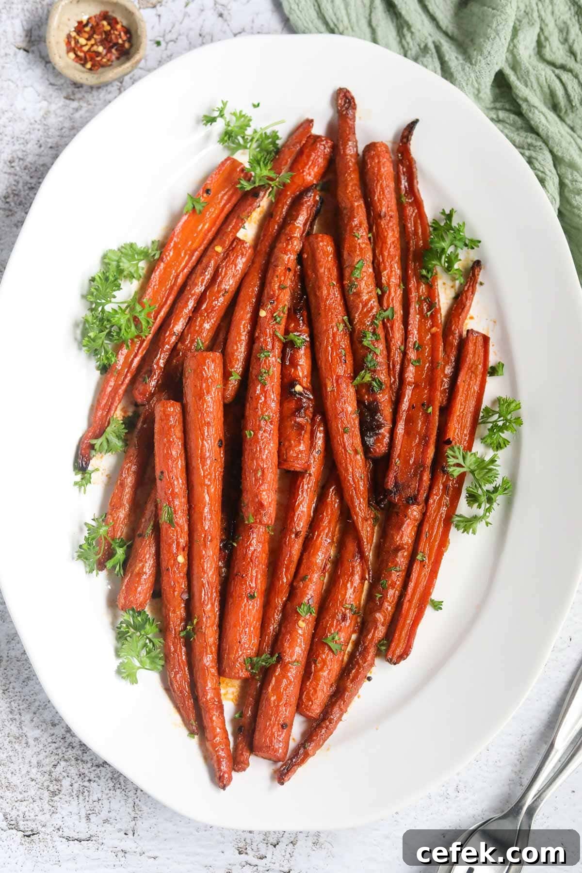 Maple-Glazed Roasted Carrots Recipe 7 Maple roasted carrots on a white platter.