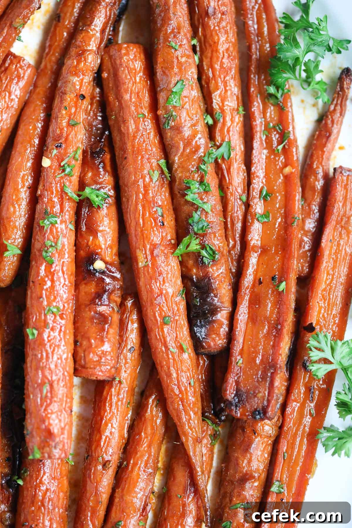 Maple-Glazed Roasted Carrots Recipe 8 Maple roasted carrots on a white platter.