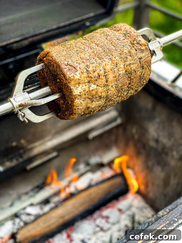 Rotisserie Prime Rib: How to Cook a Tender, Juicy Roast 15 prime rib roast on a rotisserie spit over a fire on a grill